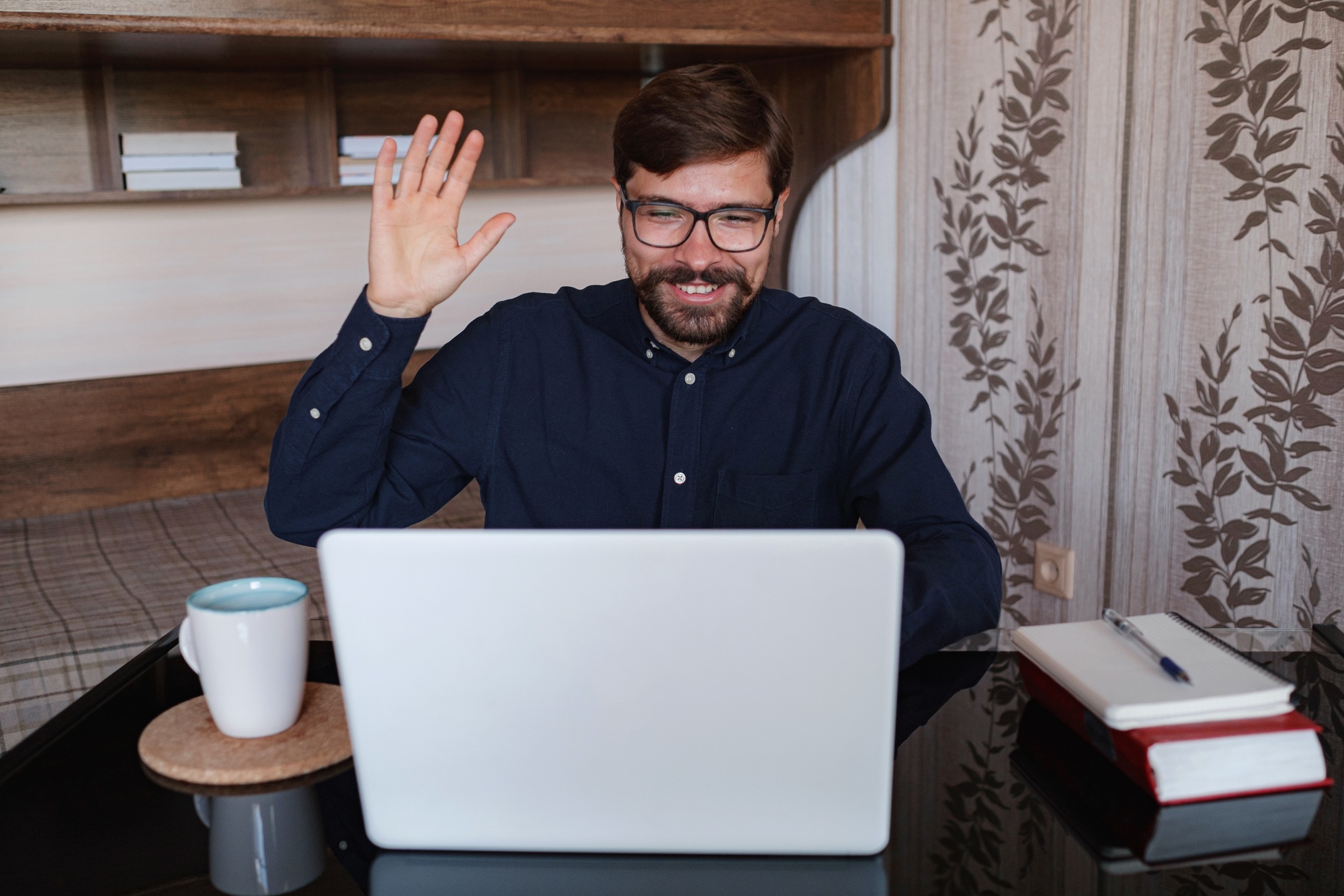 Focused man sitting at desk watching webinar video course